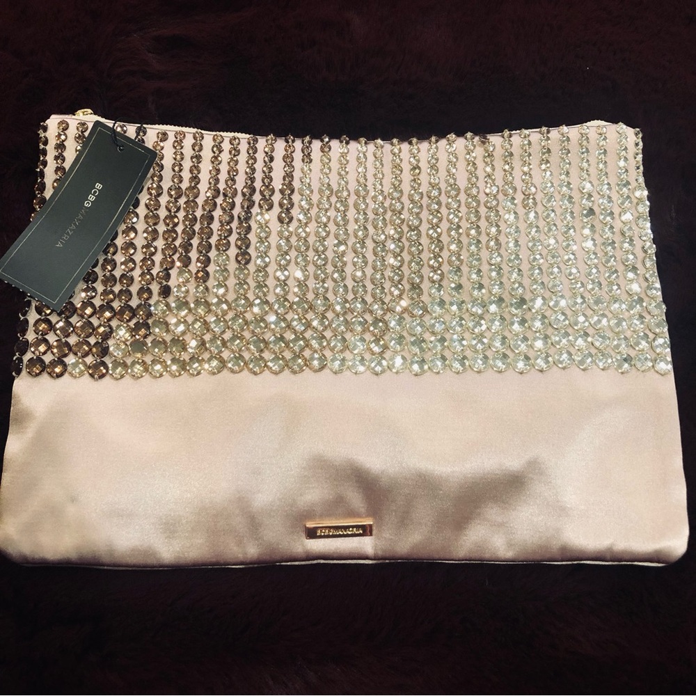 BCBGMAXAZRIA blingy satin clutch. Crystals are hombre in form. NWT And dust bag